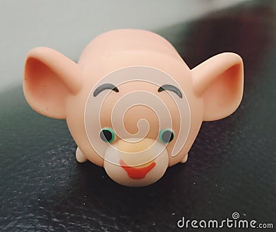 A rubber doll in the shape of a pig on a black background Stock Photo