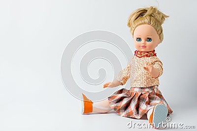 The rubber doll sits on a white background on the right side. Children`s toy. There is space for text Stock Photo