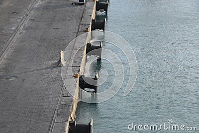 Rubber fenders attached to the pier in the port Stock Photo