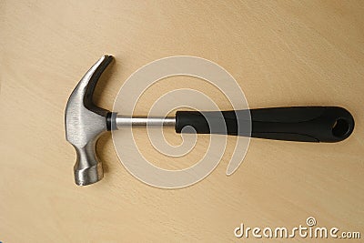 rubber-handled hammer with nail puller, round head for fine work, manual universal percussion tool for driving and extracting Stock Photo