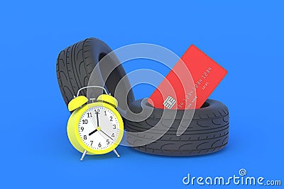 Rubber tyre near credit card and alarm clock. The cost of replacing car wheels Stock Photo