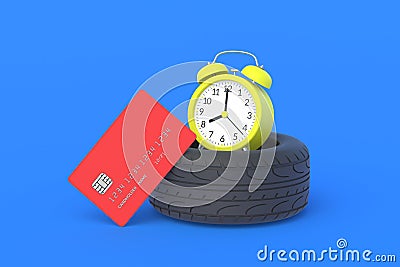 Rubber tyre near credit card and alarm clock. The cost of replacing car wheels Stock Photo