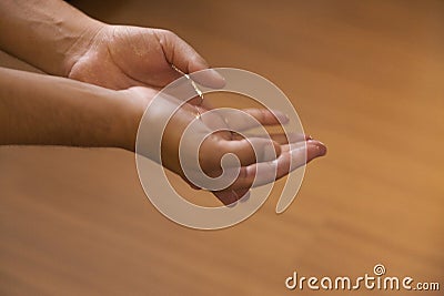 Rubbing alcohol gel on the hands Stock Photo
