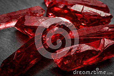 Rubies and raw crystal gems concept with closeup of a bunch of red rough uncut ruby crystals Stock Photo