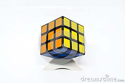Rubik cube successful orange yellow blue with stand Editorial Stock Photo