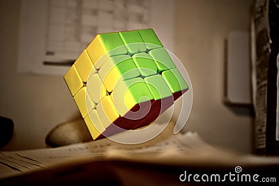 Rubiks cube in the air falls on worksheets Editorial Stock Photo