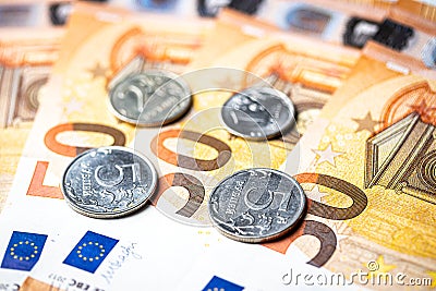 Ruble coins on the background of euro bills Stock Photo