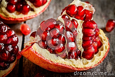 Ruby juicy pomegranate grains closeup on a table Stock Photo