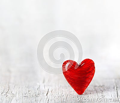 Ruby red Valentines day heart on white wood floor. For Valentine`s, love, and romance Stock Photo