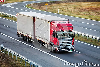 Ruck with container on highway, cargo transportation concept Stock Photo