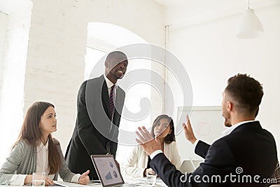 Rude angry african businessman arguing shouting at colleague dur Stock Photo