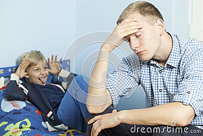 Rude son and his tired father Stock Photo