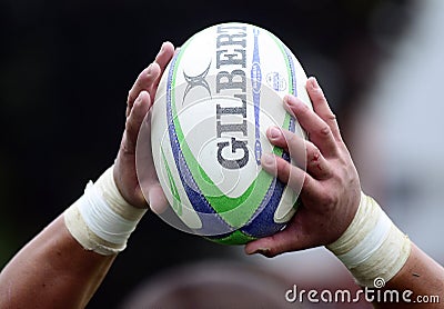 Rugby ball in hands Editorial Stock Photo