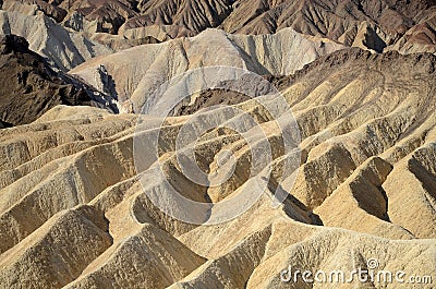 Barren, colorful desert landscape of sharp, steep ridges, mountains, gullies, and canyons Stock Photo