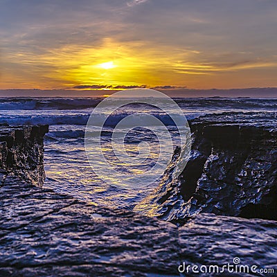 Rugged rocks by the sea in La Jolla at sunset Stock Photo