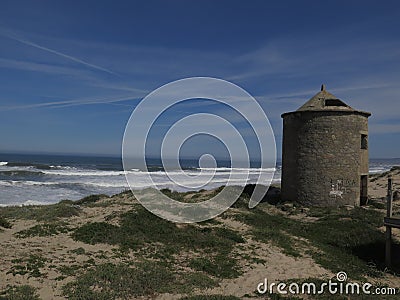 Old windmill at the ocean Stock Photo