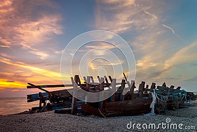 Ruin shipwreck sunset at beachside Stock Photo