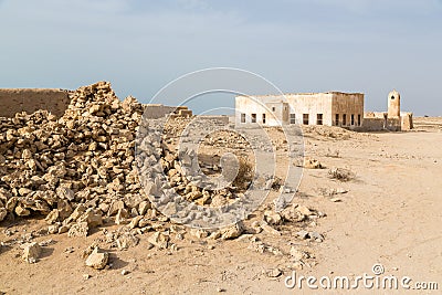Ruined ancient old Arab pearling and fishing town Al Jumail, Qatar. The desert at coast of Persian Gulf. Pile of stones. Stock Photo