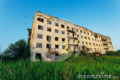 Ruined overgrown sanatorium with bullet marks, consequences of war in Abkhazia Stock Photo