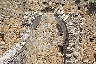 Ruined interior of an ancient medieval castle, part of the half-barrel vault roof Stock Photo