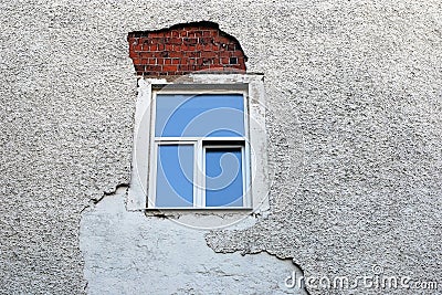 Ruined wall facing around the newly installed window frame Stock Photo