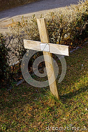 The wooden cross on the tombstone. Editorial Stock Photo