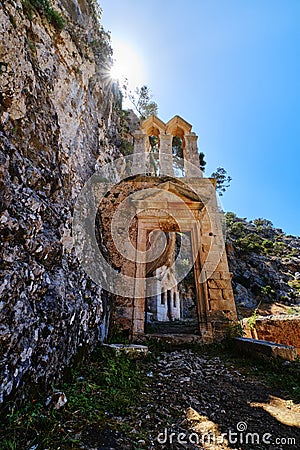 Ruins of abandoned Orthodox Katholiko monastery in Avlaki gorge, Akrotiri, Chania, Crete, Greece. Entrance gate. Upshot Stock Photo