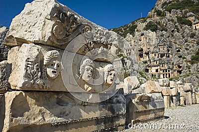 Ruins of ancient city of Myra in Demre, Turkey. Theatrical masks and faces relief and ancient rock tombs Stock Photo