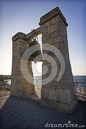 Ruins of an ancient city on the sea at sunset. The bell of Chersonesos. Stock Photo