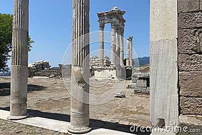 Ruins ancient city stone temple in izmir, top arches, keystones, columns, torso statue, high stone wall Stock Photo