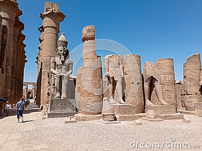 Ruins of an ancient egyptian temple with a statue of a pharaoh Editorial Stock Photo