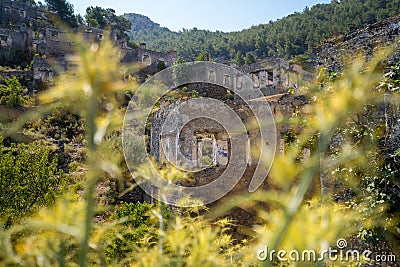 Ruins of ancient Greek houses in the ghost town of Kayakoy, view through the grass. Stock Photo