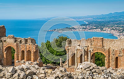 Ruins of the Ancient Greek Theater in Taormina with the sicilian coastline. Province of Messina, Sicily, southern Italy. Stock Photo
