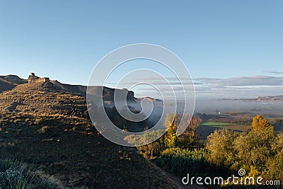 Ruins of the Arab castle in Maria de Huerva near Zaragoza early in the morning with mist in the valley Stock Photo