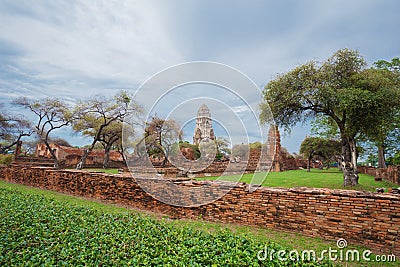 Ruins of buddha statues and pagoda of Wat Ratcha Burana in Ayutthaya historical park, Thailand Stock Photo