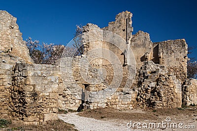 Ruins of the castle standing atop of picturesque village Stock Photo