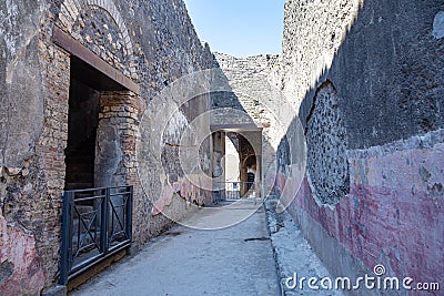 Ruins of the city of Pompeii: a narrow street of the ruined city. Pompeii, Campania, Italy Editorial Stock Photo