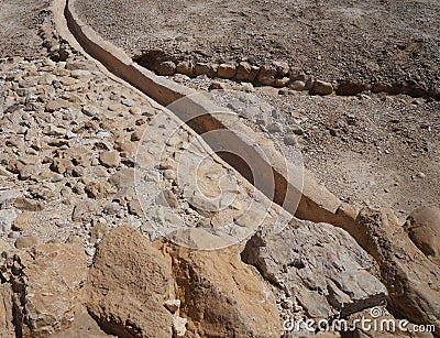 Ruins of antique village Qumran excavated by archaeologists, ancient aqueduct Stock Photo