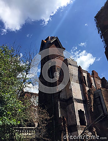Ruins of large old tower of fire damaged home Stock Photo