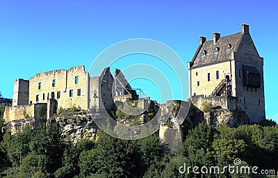 The main building and ruins of the Larochette Castle in Luxembourg wtth blue sky in the background Stock Photo