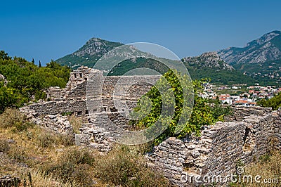 Ruins of medieval fortress with a mountain background Stock Photo