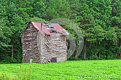 Ruins of Old Wooden Barn on Farmland Stock Photo