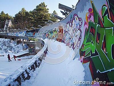 Ruins of Olympic bobsled track in Sarajevo with kids sledding Stock Photo