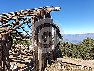 Ruins wooden shelter, Photo of old wooden framework for making tent in top of mountain Stock Photo