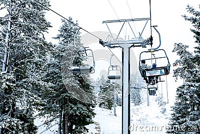 Ruka, Finland - November 24, 2012: Skiers are sitting on the chair ski lift at Ruka ski resort in freezing day Editorial Stock Photo