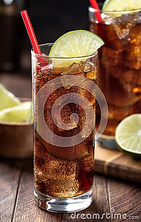 Rum and cola cocktail with lime slice in tall glasses Stock Photo