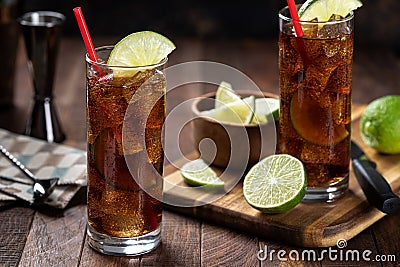 Rum and cola cocktail with lime slice in tall glasses Stock Photo