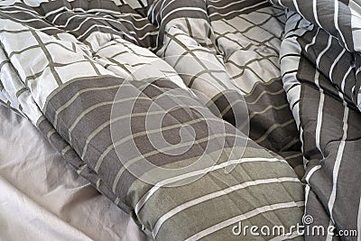 Rumpled bed comforter and sheets Stock Photo