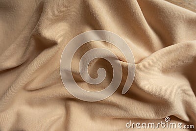 Rumpled beige cotton jersey fabric from above Stock Photo