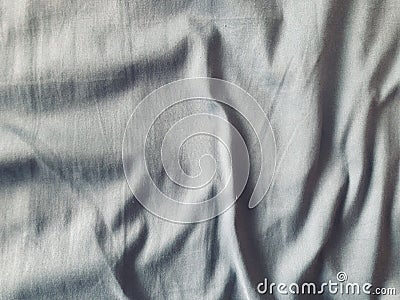 rumpled grey cotton fabric sheet in a full frame shot Stock Photo